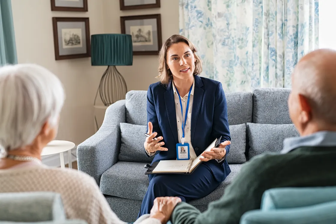 A member of the Orbis Care management team talking with a couple during a home assessment visit